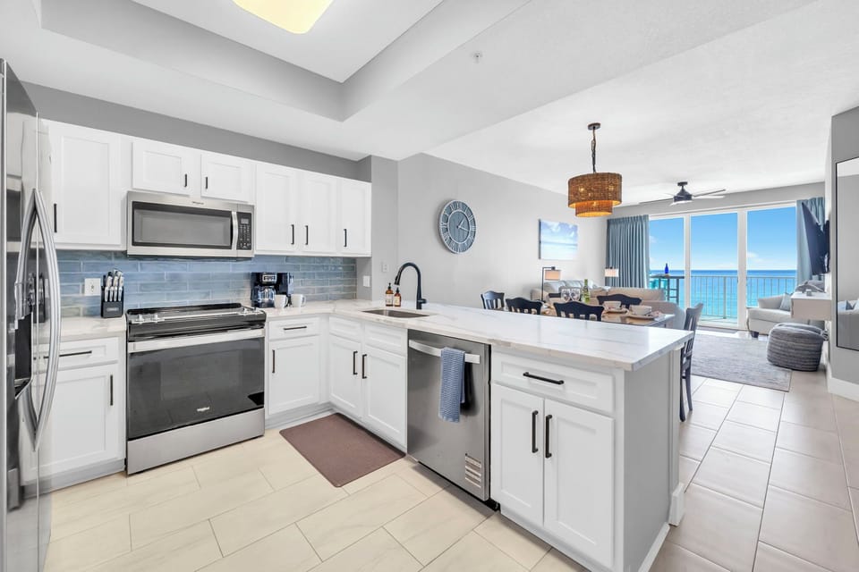 Cook with breathtaking Gulf views in this modern kitchen, featuring sleek cabinets and premium appliances that make meal prep a joy.