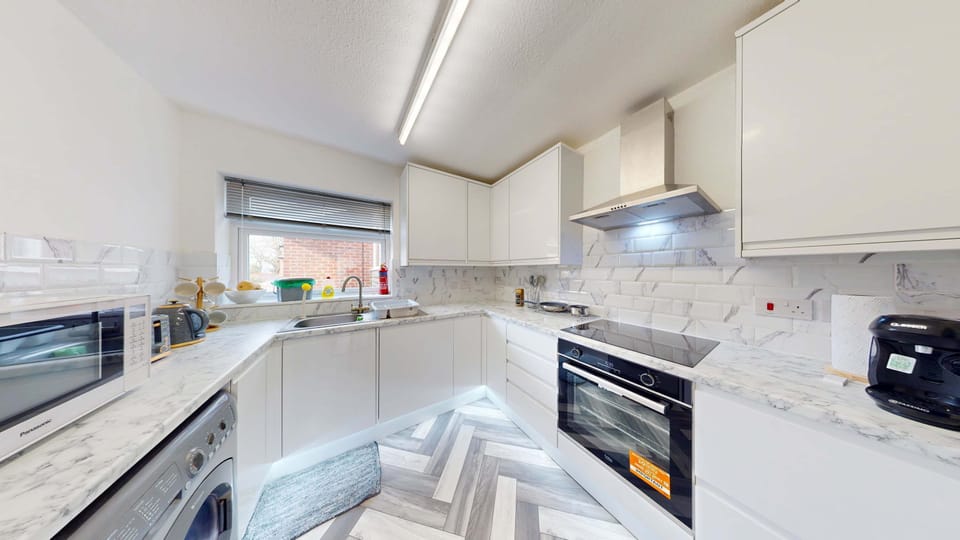 Kitchen: Modern design with sleek marble countertops and ample natural light for culinary adventures!