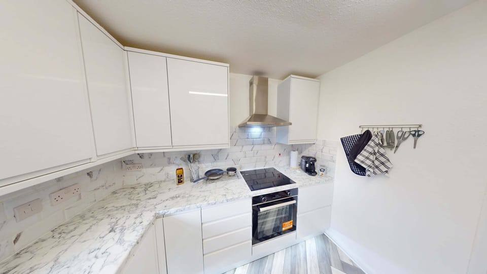 Kitchen: Modern design meets functionality with sleek surfaces and everything you need to cook up a feast!