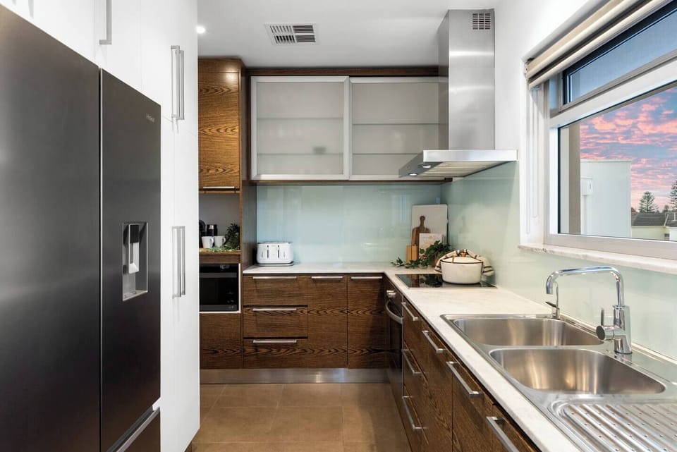 Clean lines and generous bench space make the kitchen a natural place to prep, pour, and gather.