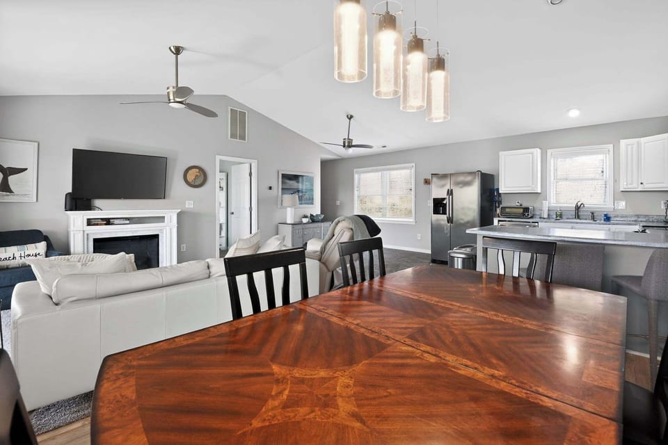 Modern touches meet homey comfort. Featuring elegant pendant lighting and a beautiful wood-inlay table, this open-concept space is as stylish as it is functional.