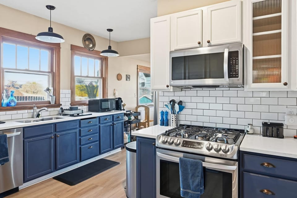 Modern Kitchen Delight: Cook up a storm in this well-appointed kitchen, featuring updated appliances, sleek cabinetry, and plenty of natural light to inspire your culinary creativity.