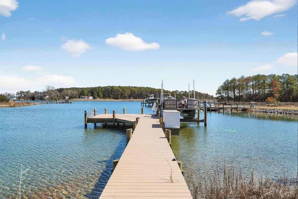 New pier with durable polywood decking! The white deck box is stocked with chairs and a fun SunChill float for your enjoyment.