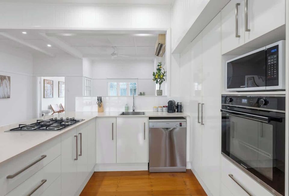 Cook with ease using modern appliances including an oven, stove, microwave and dishwasher, all set within a bright, functional space designed for effortless meal preparation.