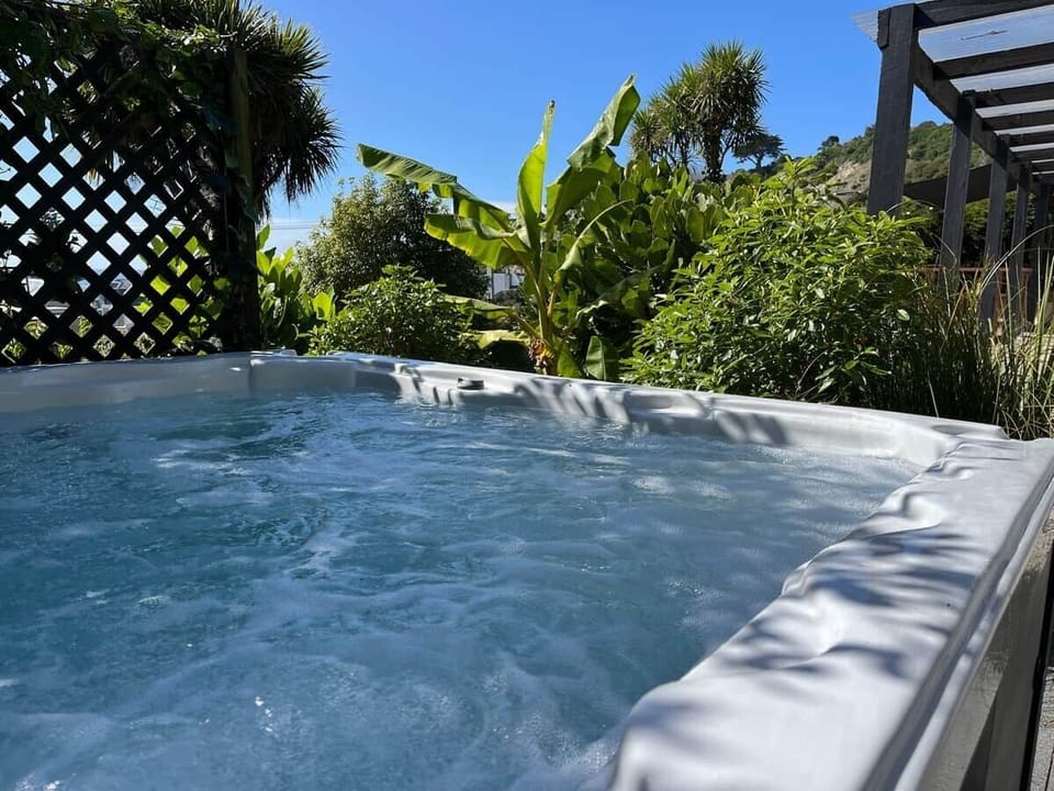 Enjoy a hot soak in the spa pool surrounded by native bush
