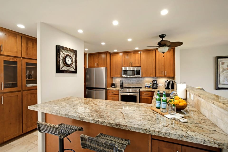 Modern gourmet kitchen with granite countertops and stainless steel appliances. KRO-L201