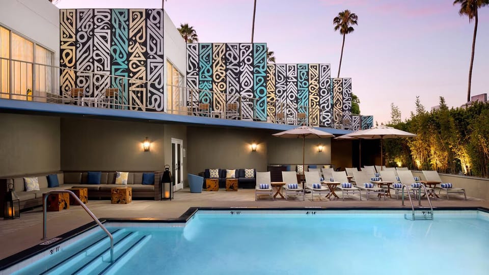 Dive into a twilight swim framed by bold, iconic architecture.