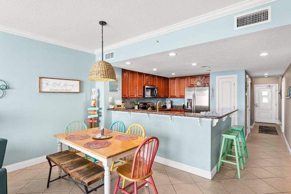 Your beach-inspired kitchen flows beautifully into the dining area, featuring granite countertops and colorful coastal charm perfect for family meals.