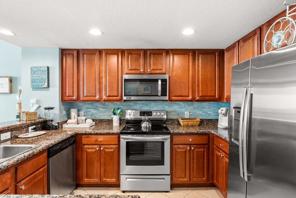 Your fully equipped kitchen features rich cherry cabinets, granite counters, and stainless appliances ready for memorable meal preparation.