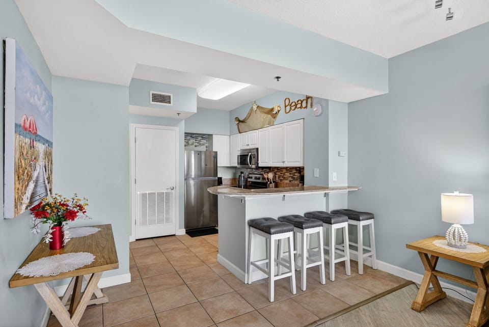 Your fully equipped kitchen awaits with modern appliances and breakfast bar seating for casual meals and morning coffee.