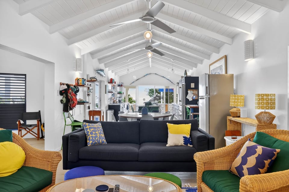 Living room overlooking the dining area and modern kitchen, creating an open and inviting space