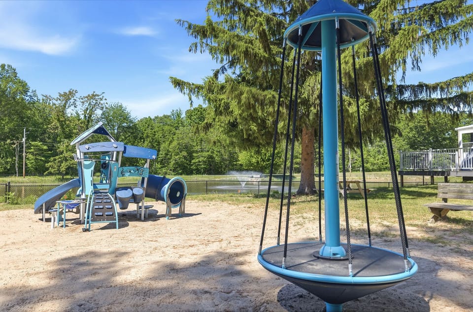Kids can enjoy their own resort experience with a dedicated playground near the pond, pools, and shared outdoor spaces.