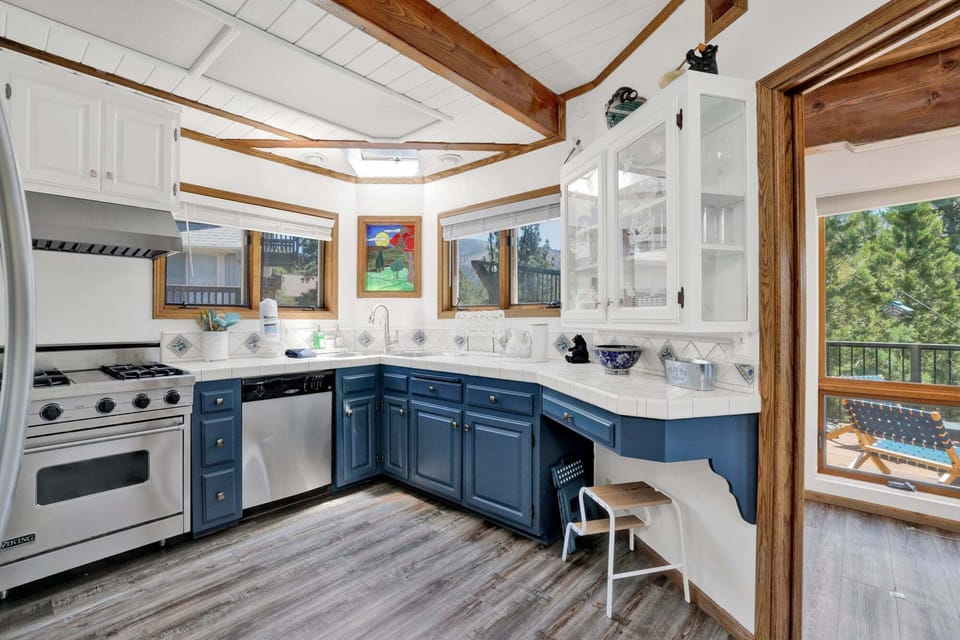 Fully equipped cabin kitchen with ample cabinetry, stove, fridge, and coffee maker—perfect for cooking meals, morning coffee, and feeling right at home on your stay.