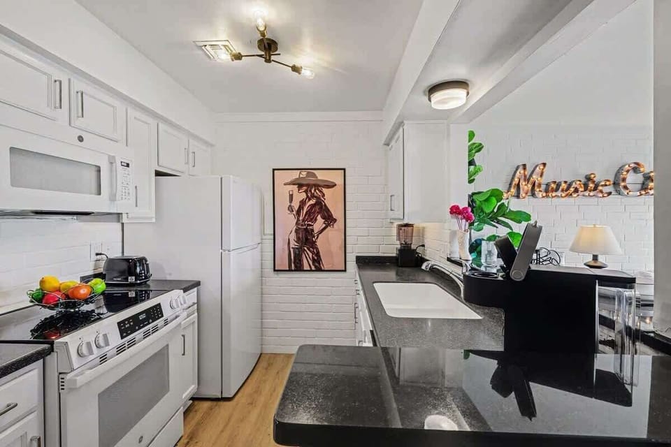 Fully equipped kitchen with stainless-steel appliances, ample counter space and bar seating for 2 guests.