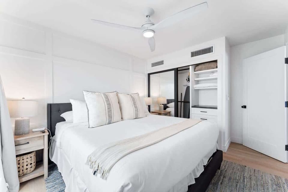 The first bedroom includes a king-size bed with fresh, clean bedding.