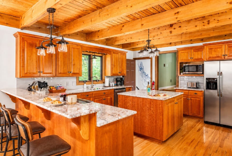 Two islands, bar seating for four, and enough counter space that everyone can be in the kitchen at once without getting in each other's way.