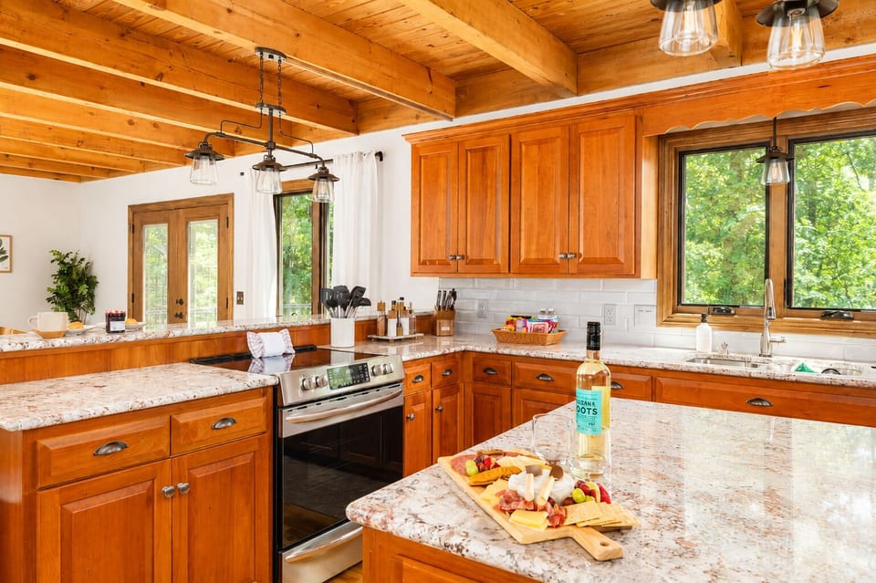 Charcuterie on the granite, wine on the counter, and the French doors right there if you want to move the party outside. It flows.