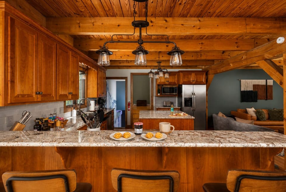 Croissants, coffee, and the whole family at the bar — the kitchen was designed for exactly this kind of morning.