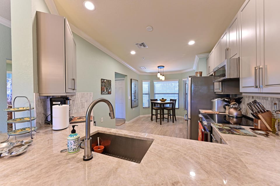 Open kitchen with granite island and stainless appliances perfect for gathering