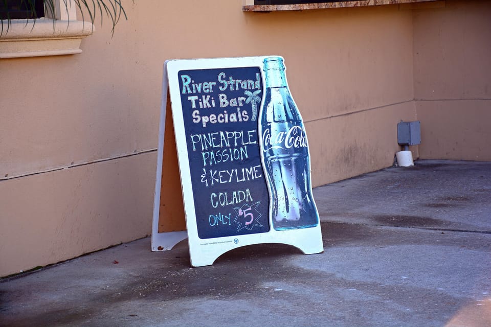 Charming sidewalk entrance with retro soda bottle chalkboard sign