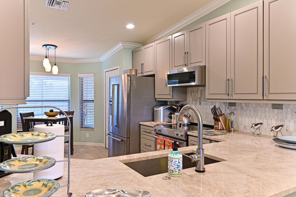 Family-ready kitchen featuring a stone island and stainless appliances