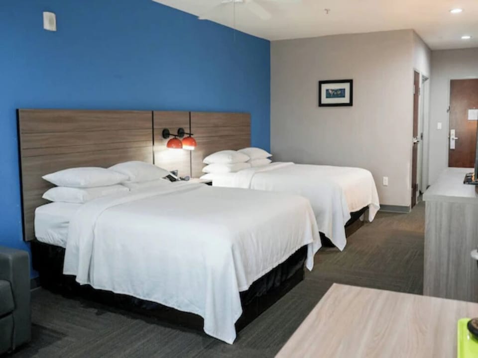 Drift off comfortably with soft linens and warm bedside lighting.