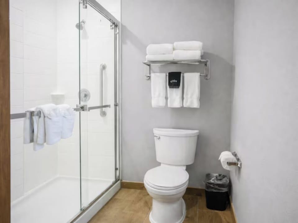 Step into a spotless bathroom with fresh towels and amenities.