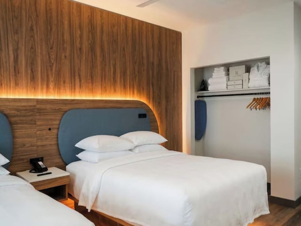 Recharge in twin beds with warm wood accents and clean design.