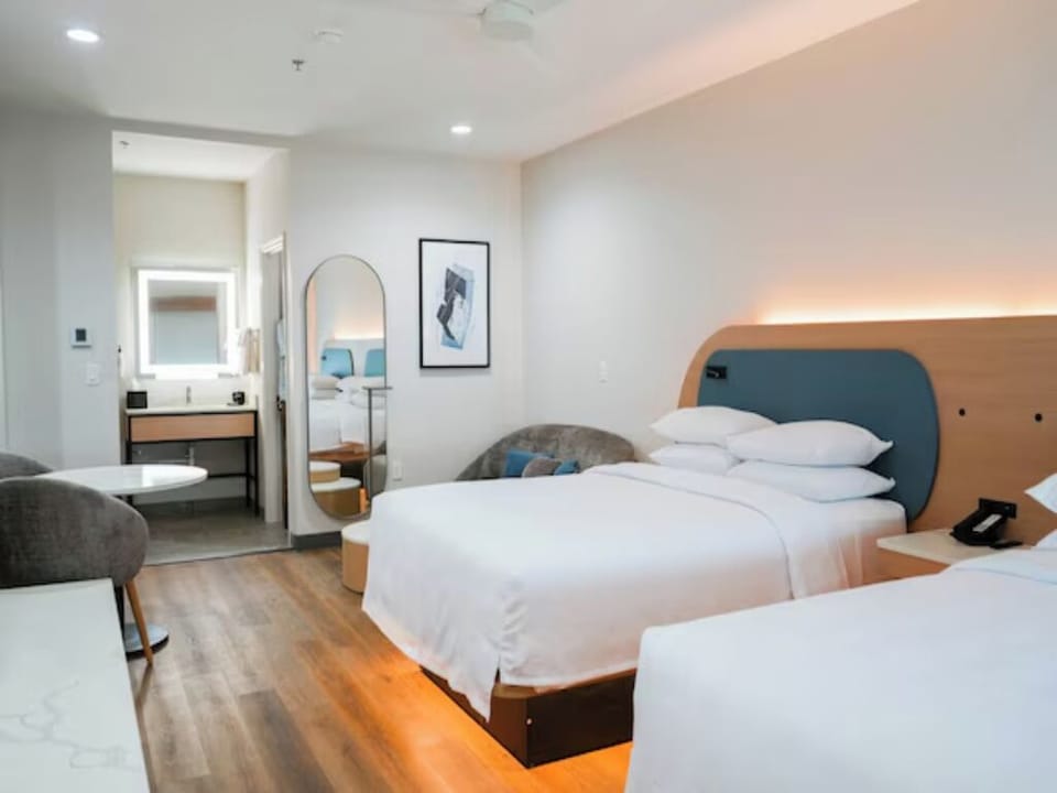 Unwind in a bright modern room with warm underbed glow.