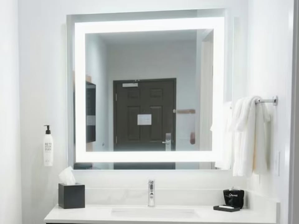 Freshen up under bright lighting at the modern vanity.