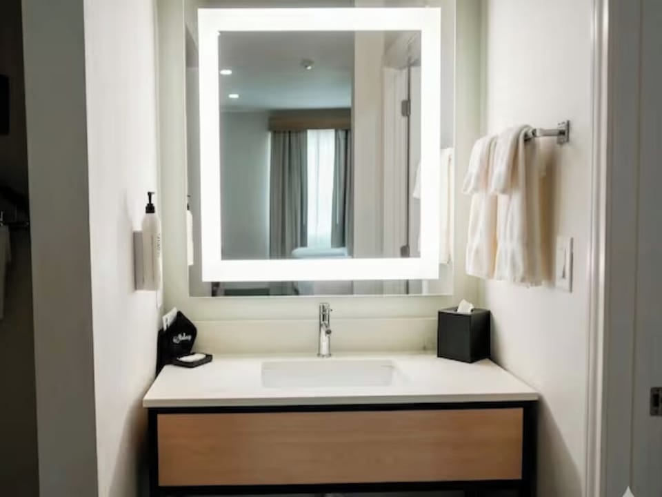Get ready smoothly with a sleek vanity and spa-bright mirror.
