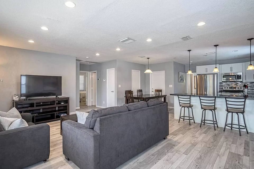 Open-concept layout connecting living, dining, and kitchen—designed for a seamless, social stay.