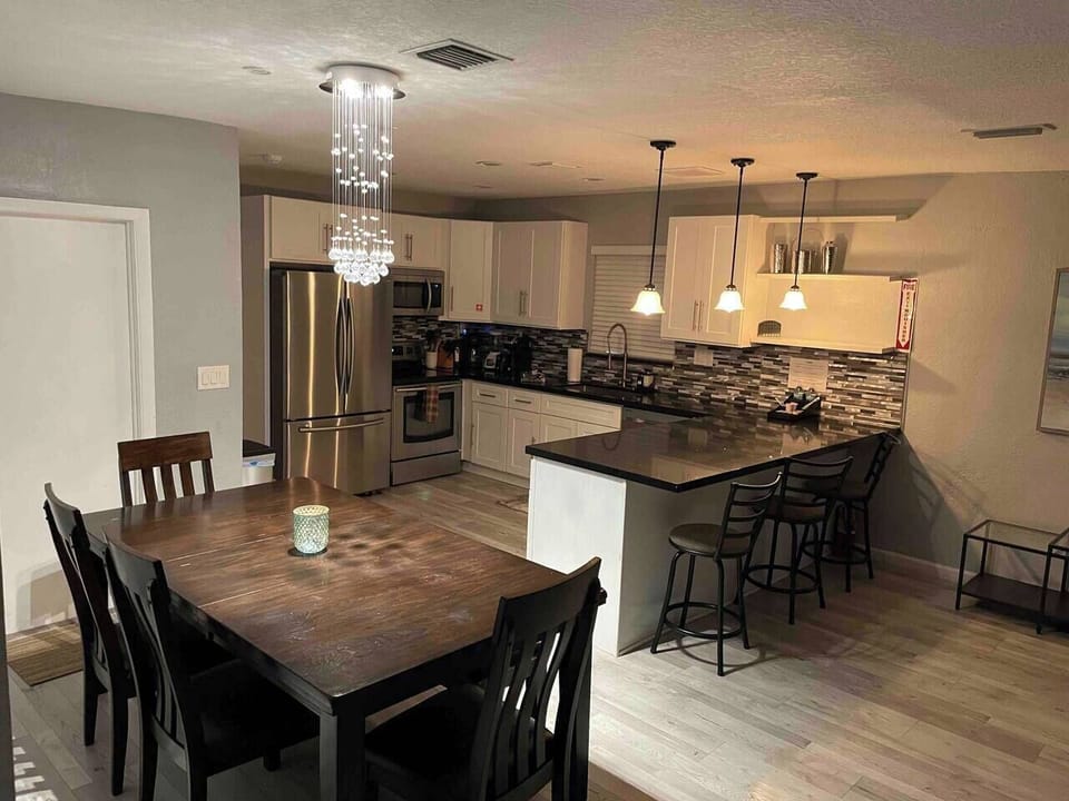Open dining and kitchen layout with bar seating—perfect for shared meals and gathering together.