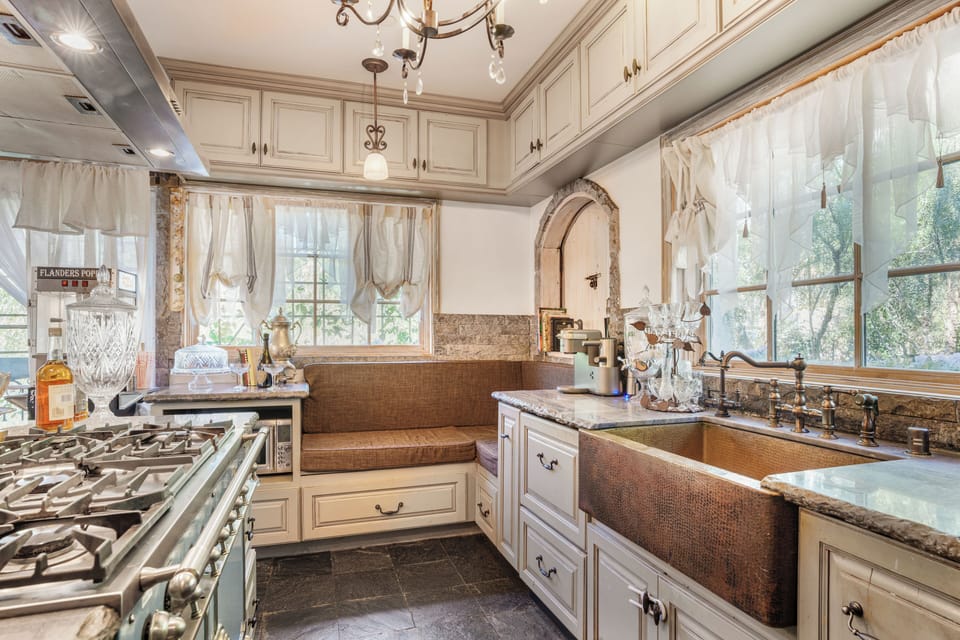 Gourmet scullery featuring a copper sink and custom cabinetry