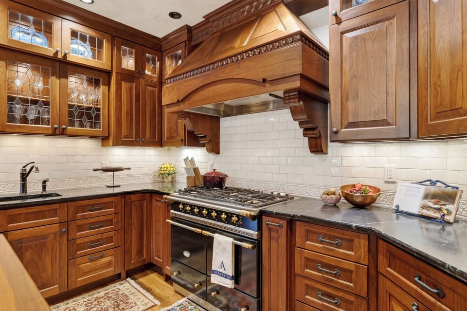 A chef’s kitchen with custom cabinetry, premium appliances, and a large island for easy gathering.