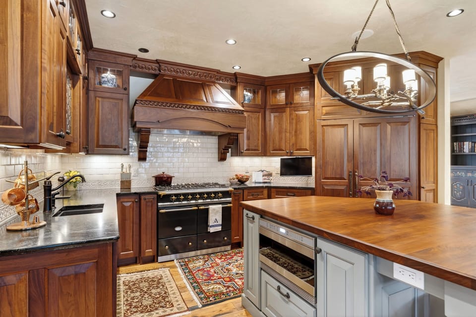 A chef’s kitchen with custom cabinetry, premium appliances, and a large island for easy gathering.