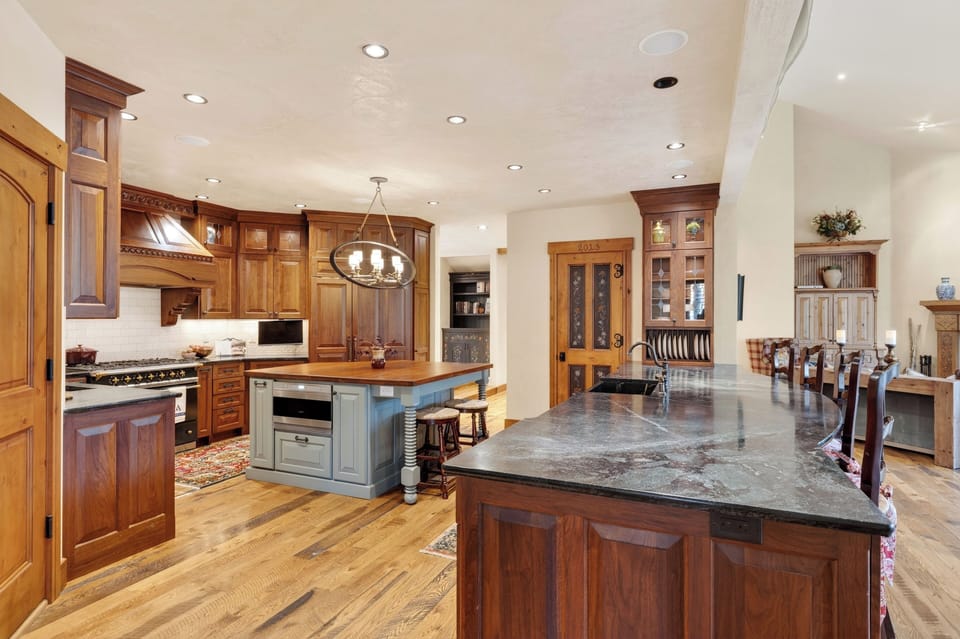 A chef’s kitchen with custom cabinetry, premium appliances, and a large island for easy gathering.