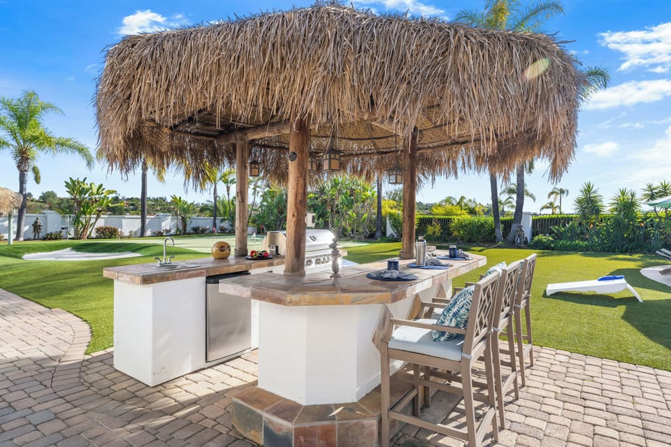 Tropical outdoor kitchen and palapa‑style bar — perfect for grilling, cocktails, and laid‑back Temecula afternoons.