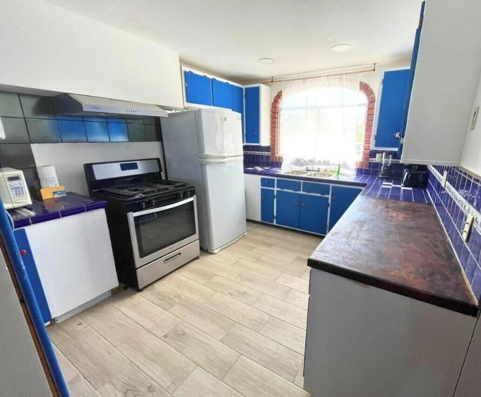 Prepare fresh meals in the full kitchen at Casa Barber vacation rental in San Felipe — stove, fridge, and counter space included for your group
