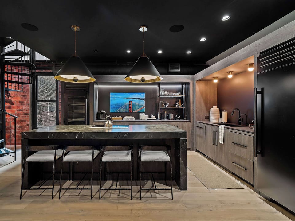 Modern kitchen w/ long island, bar seating & sleek finishes for easy entertaining