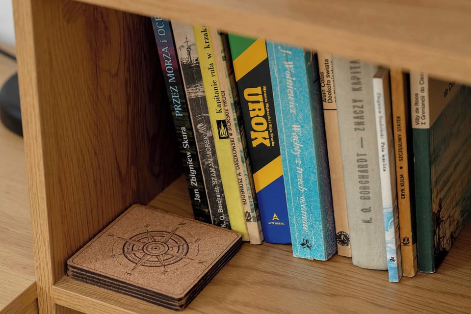 Close-up of a bookshelf with books and decorative objects. It adds a cozy, personal touch to the open studio.