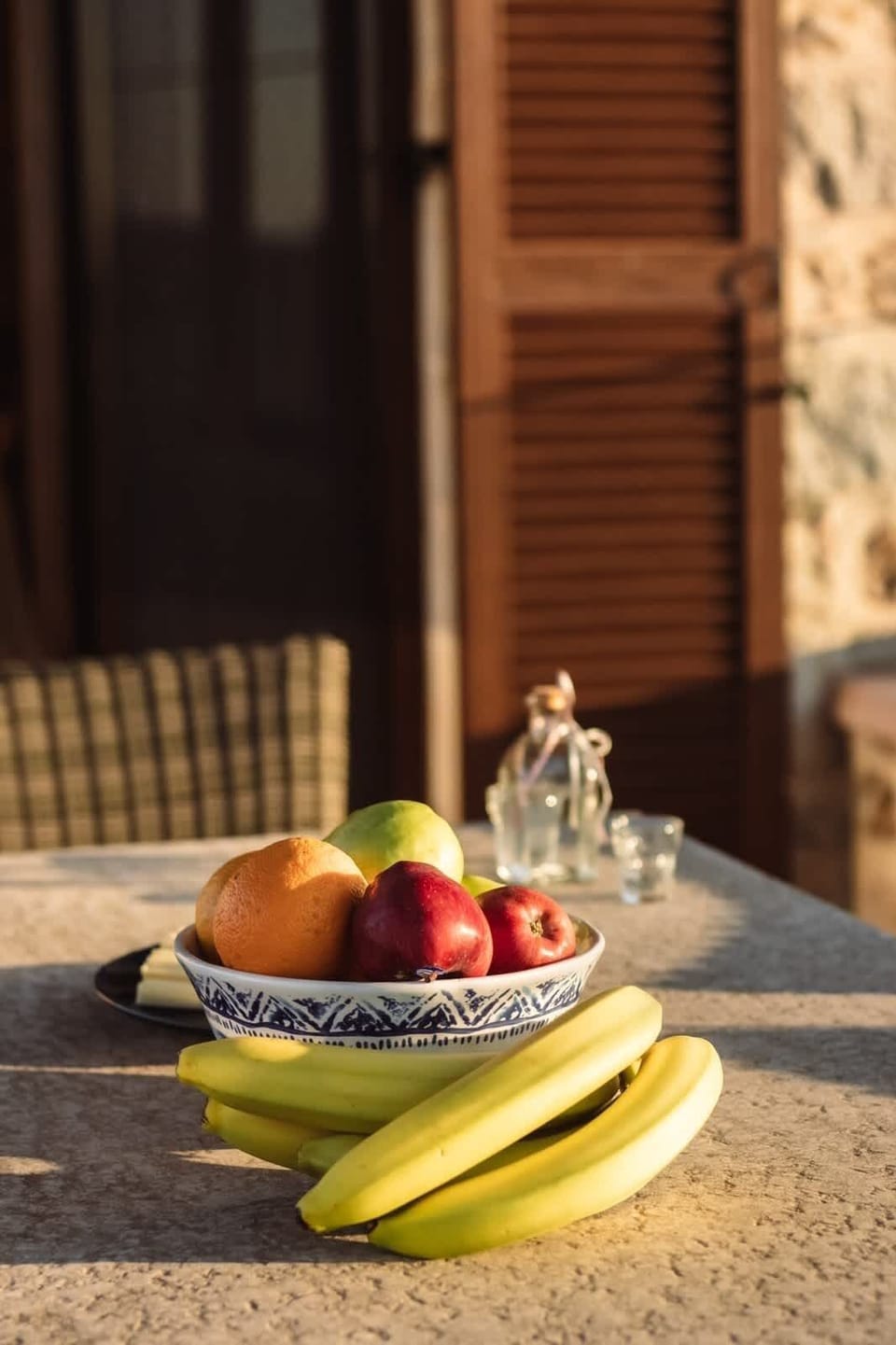 Terrace detail with fruit and sunlight, capturing the relaxed pace of mornings at the villa.