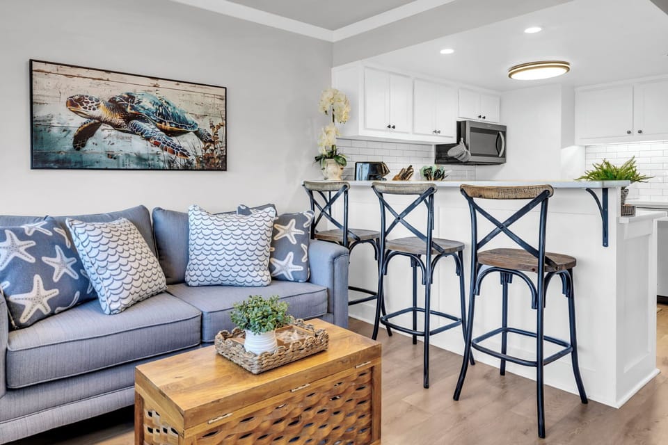 Settle into your coastal living space where sea turtle art meets cozy comfort, perfect for relaxing after beach days.