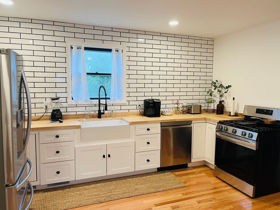 Your spacious kitchen awaits with modern appliances, butcher-block counters, and farmhouse charm for memorable meal prep.