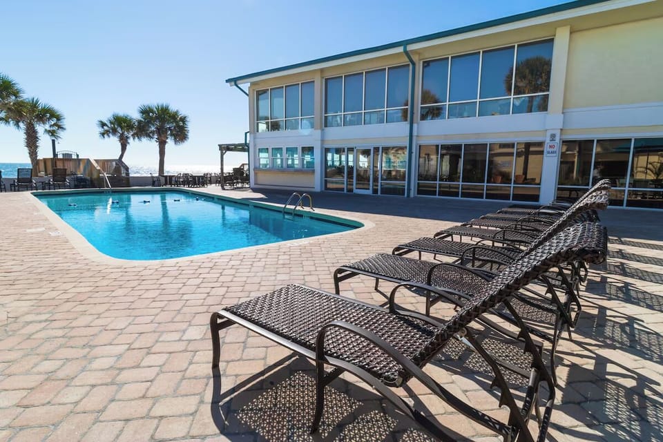Stretch out on loungers beside the sparkling seaside pool.