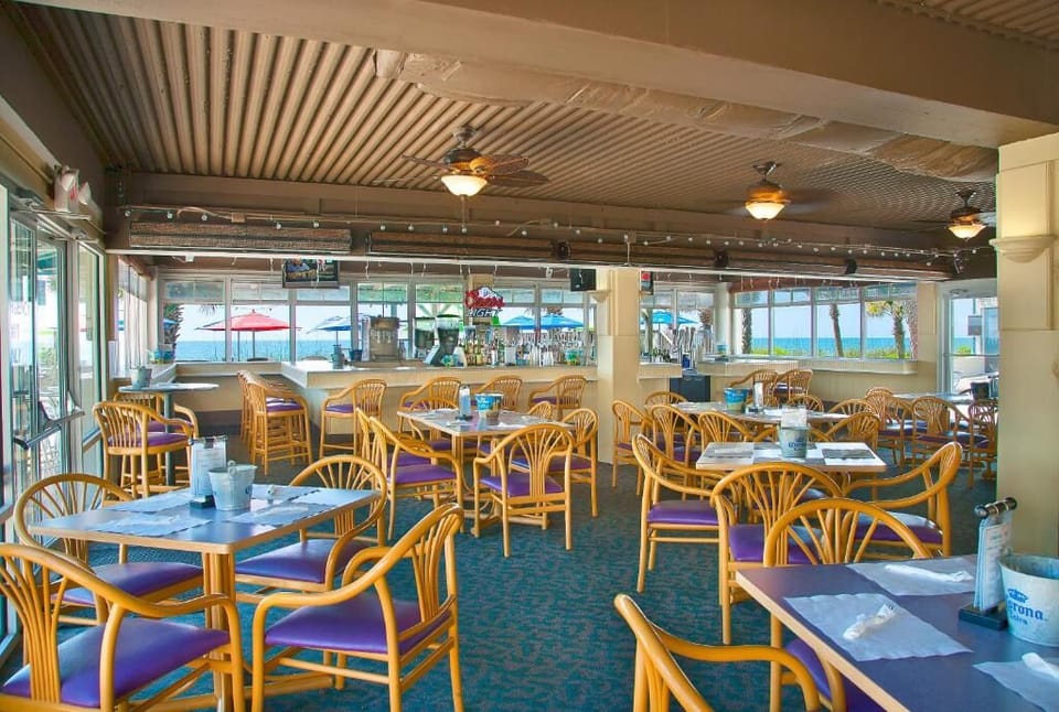 Settle in with friends for casual dining steps from sand.