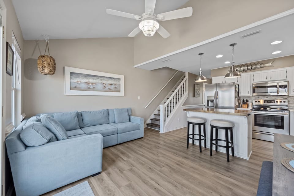 Open living area with sectional seating and breakfast bar