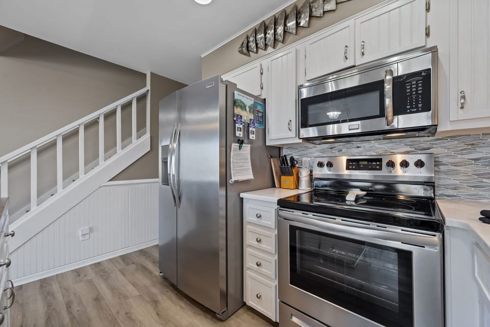 Fully equipped kitchen with stainless steel appliances and everything you need to cook meals during your stay