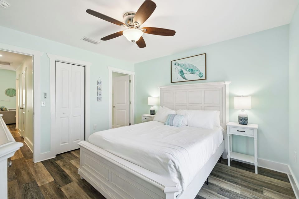 Drift off to sleep in your peaceful retreat with soft mint walls, crisp linens, and gentle ceiling fan breezes.