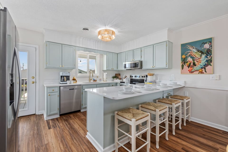 Gorgeous remodeled kitchen with bar seating for 4, stainless steel appliances, K-Cup & drip coffee makers, dishwasher, stove, microwave, fridge/freezer, and fully stocked cookware and dinnerware.